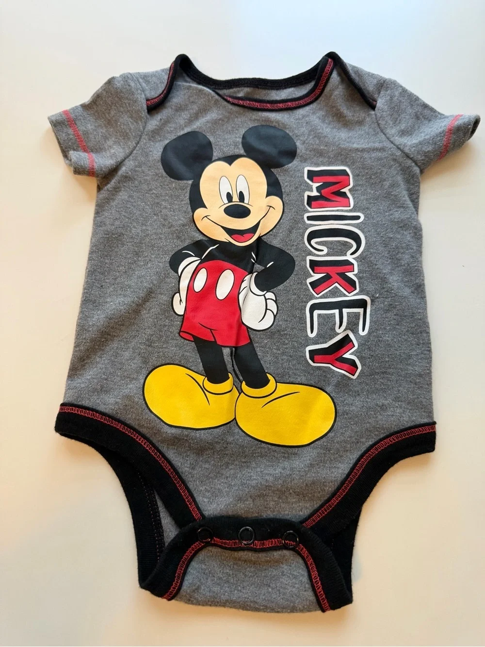 Disney Gray Mickey Mouse Graphic One-Piece with Yellow, Red and Black Accents